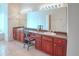 Bathroom vanity area with double sink, large mirror, and wooden cabinets at 318 Rock Springs Dr, Poinciana, FL 34759