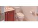 Bathroom sink and a toilet with dark cabinets at 318 Rock Springs Dr, Poinciana, FL 34759