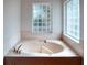 A bathtub is featured with glass block windows and a sleek and stylish design at 318 Rock Springs Dr, Poinciana, FL 34759