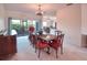 Airy dining space featuring an oversized wooden table and a view of the patio at 318 Rock Springs Dr, Poinciana, FL 34759