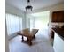 Dining room area featuring carpet flooring and a view of the living room and backyard at 318 Rock Springs Dr, Poinciana, FL 34759