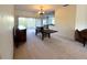 Open dining area with carpet flooring, sliding glass doors, and dark wood furniture at 318 Rock Springs Dr, Poinciana, FL 34759