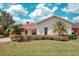 Charming single-story home with a manicured lawn, mature landscaping, and a welcoming facade at 318 Rock Springs Dr, Poinciana, FL 34759