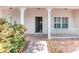 Inviting covered porch with classic columns and a brick-paved walkway leading to the front door at 318 Rock Springs Dr, Poinciana, FL 34759