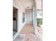 Cozy front porch with classic pillars and brick flooring, offering a glimpse into the home's interior at 318 Rock Springs Dr, Poinciana, FL 34759