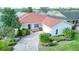 Charming single-story home featuring a red roof, a manicured lawn and a brick paver driveway at 318 Rock Springs Dr, Poinciana, FL 34759