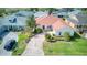 Well-maintained property featuring a red roof, green lawn, and a brick paver driveway at 318 Rock Springs Dr, Poinciana, FL 34759
