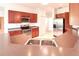 Open kitchen features stainless steel appliances, wooden cabinetry and double bowl sink at 318 Rock Springs Dr, Poinciana, FL 34759
