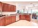 Kitchen offers wooden cabinets, stone countertops, and stainless steel dishwasher with dining area at 318 Rock Springs Dr, Poinciana, FL 34759