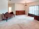 Large living room with vintage furniture, carpet, and large windows at 318 Rock Springs Dr, Poinciana, FL 34759