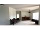 Bright living room featuring vaulted ceilings, neutral walls, carpet, and a vintage brown sofa at 318 Rock Springs Dr, Poinciana, FL 34759
