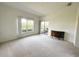 Spacious living room featuring carpet flooring, neutral paint, and natural light from large windows at 318 Rock Springs Dr, Poinciana, FL 34759