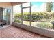 A screened patio features a brick floor, screen windows and sunlight at 318 Rock Springs Dr, Poinciana, FL 34759