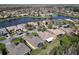 Scenic aerial view of a tranquil waterfront community showcasing beautiful homes at 400 Indian Wells Ave, Poinciana, FL 34759