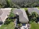 An aerial view shows this house with lush landscaping, walkways, and a brick paver driveway at 400 Indian Wells Ave, Poinciana, FL 34759