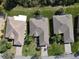 Aerial view of a well-maintained home with a screened lanai and lush landscaping at 400 Indian Wells Ave, Poinciana, FL 34759
