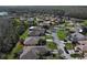 A scenic aerial view shows this property with lush landscaping, a screen enclosed lanai, and neighboring houses at 400 Indian Wells Ave, Poinciana, FL 34759