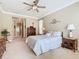 Cozy bedroom featuring carpet, ceiling fan, and neutral walls, creating a relaxing atmosphere at 400 Indian Wells Ave, Poinciana, FL 34759