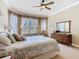 Bedroom with natural light through bay windows, decorated with soft, neutral tones and cozy furniture at 400 Indian Wells Ave, Poinciana, FL 34759