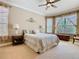 Spacious bedroom with a ceiling fan, two windows, and neutral-colored walls and carpet at 400 Indian Wells Ave, Poinciana, FL 34759