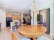 View of the breakfast nook leading to the kitchen; a black refrigerator and bar seating are visible at 400 Indian Wells Ave, Poinciana, FL 34759