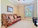 Comfortable den features a window, neutral walls, plush carpet, and a futon sofa at 400 Indian Wells Ave, Poinciana, FL 34759