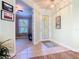 Welcoming foyer with tile flooring, a decorative front door, and a view into the adjacent living spaces at 400 Indian Wells Ave, Poinciana, FL 34759