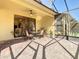 Spacious screened lanai features brick flooring, ceiling fan, and outdoor seating at 400 Indian Wells Ave, Poinciana, FL 34759