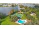 Beautiful aerial view of the pool and tennis courts with the lake in the background at 406 Oak Haven Dr # 406, Altamonte Springs, FL 32701
