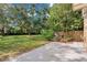 Lush backyard featuring a mix of grass, trees, and partial brick wall surrounding the property at 406 Oak Haven Dr # 406, Altamonte Springs, FL 32701
