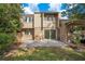 A spacious backyard with a concrete patio, partial brick wall, and sliding door access to the home at 406 Oak Haven Dr # 406, Altamonte Springs, FL 32701