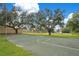 An outdoor basketball court with hoops, surrounded by grass and trees at 406 Oak Haven Dr # 406, Altamonte Springs, FL 32701