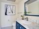 Stylish bathroom featuring a blue vanity with marble countertop and modern fixtures at 406 Oak Haven Dr # 406, Altamonte Springs, FL 32701