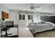 A comfortable bedroom with a ceiling fan, a mirrored wall, and a desk for remote work at 406 Oak Haven Dr # 406, Altamonte Springs, FL 32701