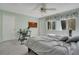 Comfortable bedroom with a large window, ceiling fan, and dedicated desk space for a home office setup at 406 Oak Haven Dr # 406, Altamonte Springs, FL 32701