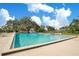 A clean community swimming pool with lounge chairs, tables, and mature shade trees at 406 Oak Haven Dr # 406, Altamonte Springs, FL 32701
