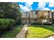 Charming townhome exterior featuring a well-maintained lawn and a quaint walkway leading to the front door at 406 Oak Haven Dr # 406, Altamonte Springs, FL 32701