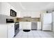 Bright kitchen featuring white cabinets, stainless steel appliances, and tiled backsplash at 406 Oak Haven Dr # 406, Altamonte Springs, FL 32701