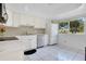 Well-lit kitchen features white cabinetry, stainless steel appliances, and a view of the outdoors at 406 Oak Haven Dr # 406, Altamonte Springs, FL 32701
