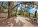 Outdoor patio with brick pavers, outdoor kitchen, and tables underneath mature trees for entertaining guests at 406 Oak Haven Dr # 406, Altamonte Springs, FL 32701