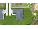 Aerial view of a house with a gray roof, well-maintained lawn, and a neighboring property at 41 Peterlee Ct, Kissimmee, FL 34758