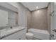 A bathroom offers a tiled tub with a shower, complemented by a modern vanity with a granite countertop at 41 Peterlee Ct, Kissimmee, FL 34758