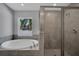 Bathroom includes soaking tub and glass shower with tile surround and natural light at 41 Peterlee Ct, Kissimmee, FL 34758