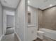 A bathroom showcases tiled shower over tub, granite-topped vanity, and neutral tile floors for a clean, modern aesthetic at 41 Peterlee Ct, Kissimmee, FL 34758