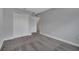 A comfortable bedroom with a view to a closet and a doorway, featuring neutral decor and plush carpeting at 41 Peterlee Ct, Kissimmee, FL 34758
