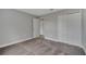 A spacious bedroom includes closet and doorway, featuring neutral gray walls and plush, patterned carpeting at 41 Peterlee Ct, Kissimmee, FL 34758