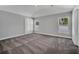 A spacious bedroom has soft carpet flooring and natural light from two windows at 41 Peterlee Ct, Kissimmee, FL 34758