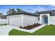 A charming home featuring a two-car garage and vibrant, colorful landscaping at 41 Peterlee Ct, Kissimmee, FL 34758