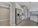 Bright kitchen area with stainless steel fridge, granite counters, and neutral palette at 41 Peterlee Ct, Kissimmee, FL 34758