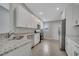 Modern kitchen with granite countertops, stainless steel appliances and tile flooring at 41 Peterlee Ct, Kissimmee, FL 34758